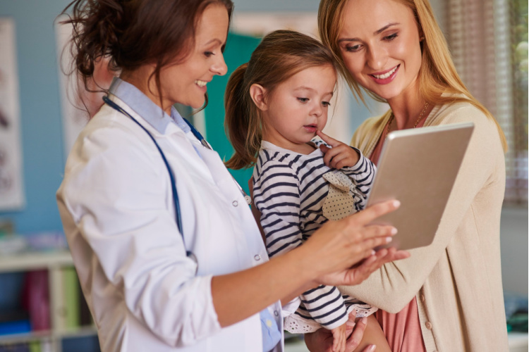 Nurse with mom holding her daughter